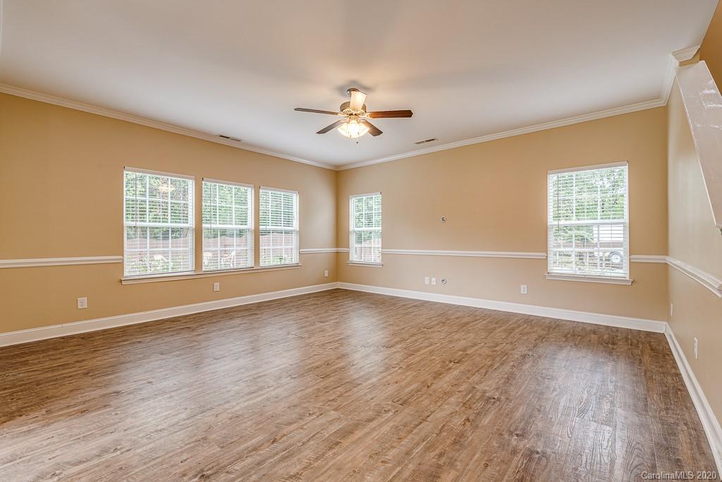 2510 Fletcher Broome Road Monroe, NC 28112 - Photo 15 of 48 an empty room with wooden floor ceiling fan and windows