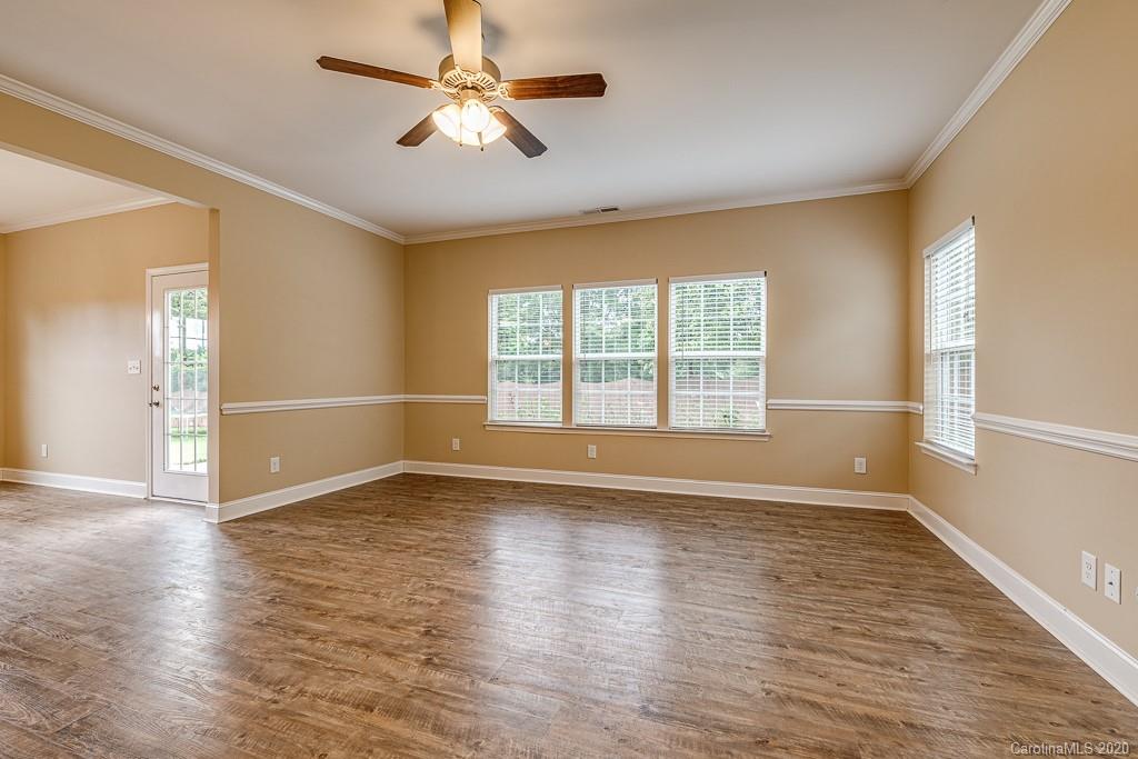 2510 Fletcher Broome Road Monroe, NC 28112 - Photo 18 of 48 an empty room with wooden floor fan and windows