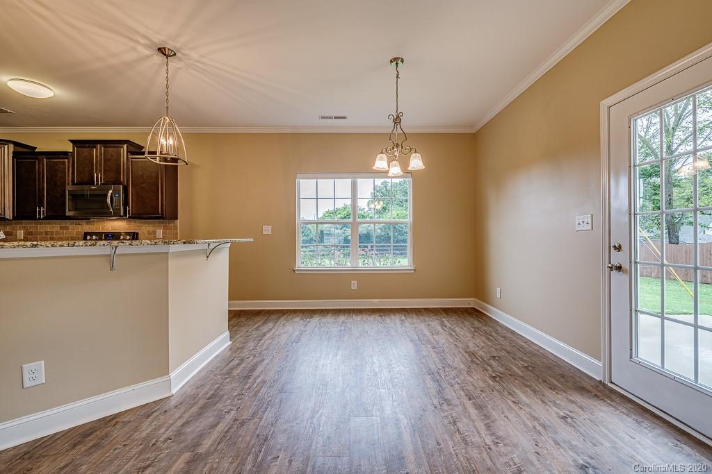 2510 Fletcher Broome Road Monroe, NC 28112 - Photo 21 of 48 a view of a room with wooden floor a ceiling fan and windows