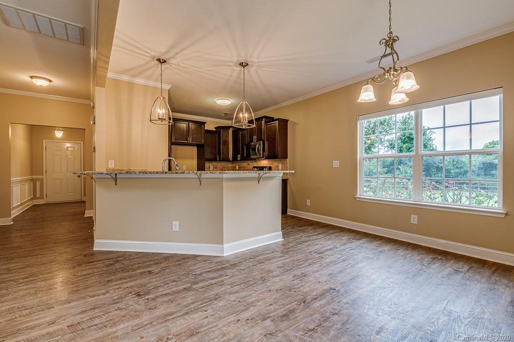 2510 Fletcher Broome Road Monroe, NC 28112 - Photo 22 of 48 a view of a kitchen with a sink wooden floor and windows