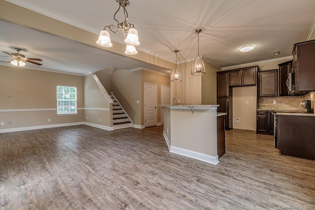 2510 Fletcher Broome Road Monroe, NC 28112 - Photo 23 of 48 a view of a kitchen with a refrigerator wooden floor and a kitchen