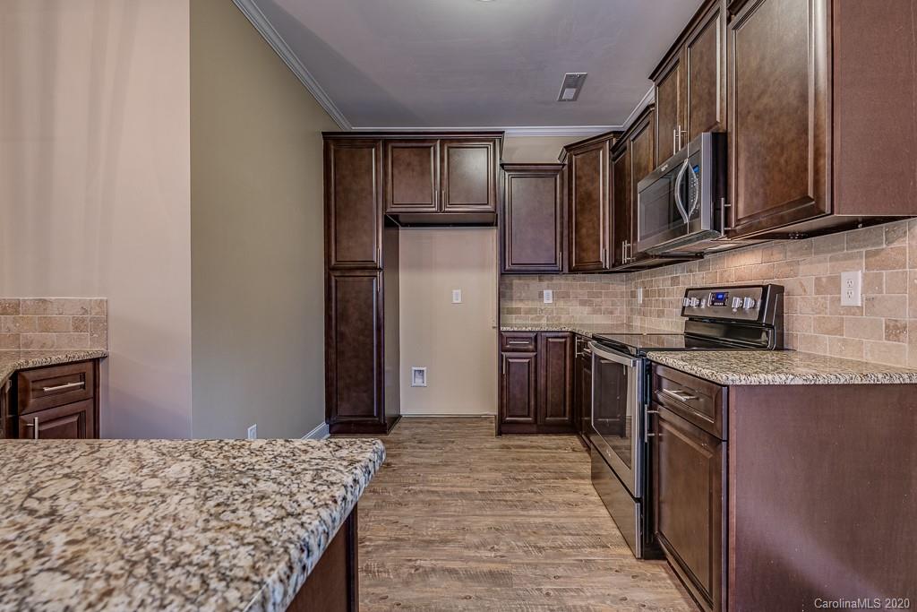2510 Fletcher Broome Road Monroe, NC 28112 - Photo 24 of 48 a kitchen with stainless steel appliances granite countertop a refrigerator stove top oven a sink and dishwasher