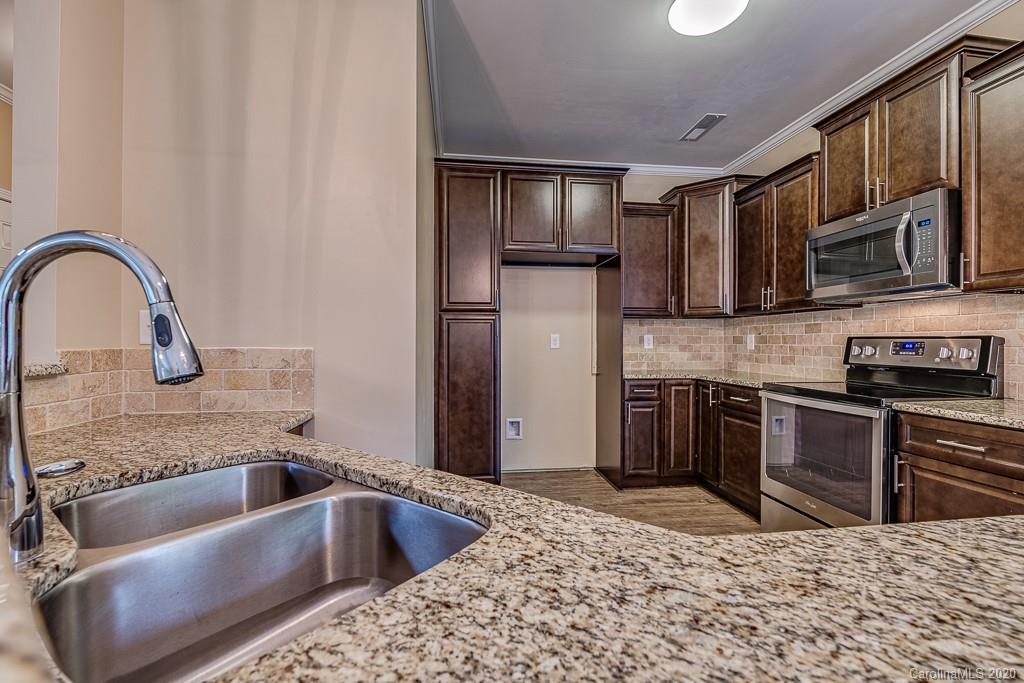 2510 Fletcher Broome Road Monroe, NC 28112 - Photo 25 of 48 a kitchen with stainless steel appliances granite countertop a sink and a refrigerator