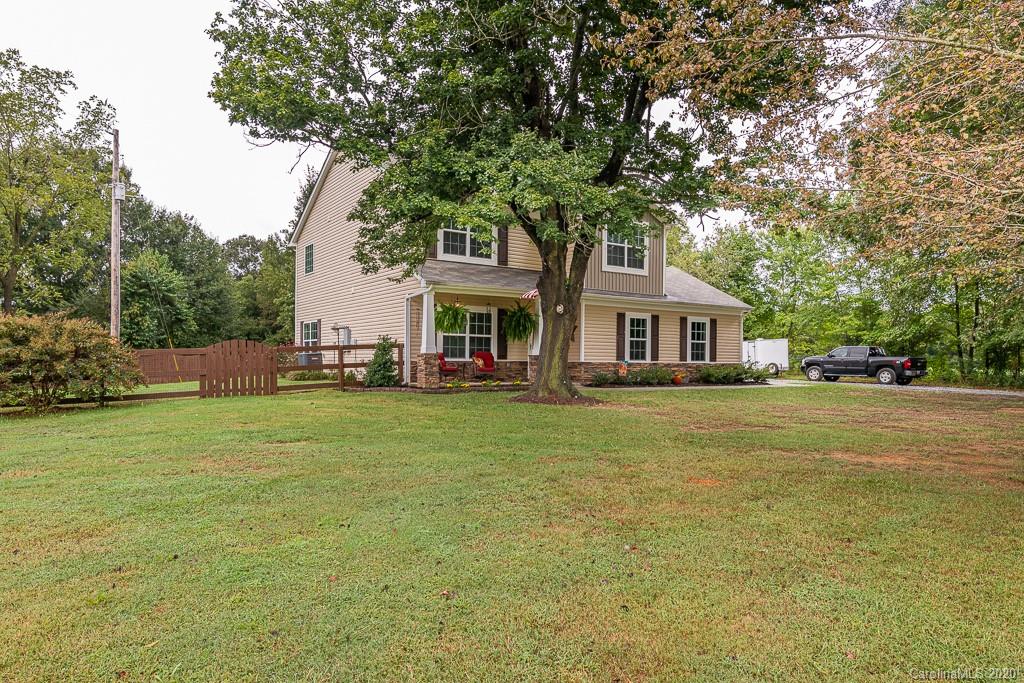 2510 Fletcher Broome Road Monroe, NC 28112 - Photo 5 of 48 a front view of a house with a garden and trees
