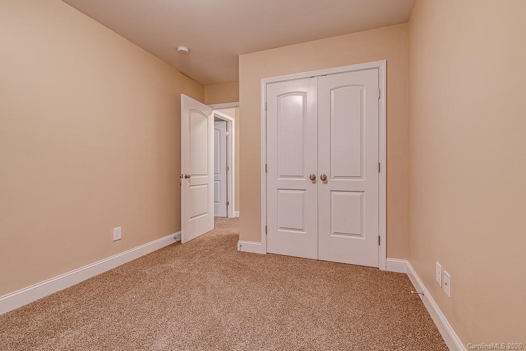 2510 Fletcher Broome Road Monroe, NC 28112 - Photo 44 of 48 an empty room with white cabinet and mirror