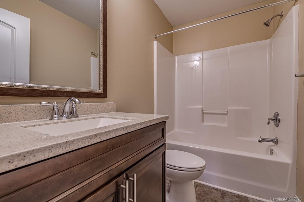 2510 Fletcher Broome Road Monroe, NC 28112 - Photo 45 of 48 a bathroom with a granite countertop sink toilet and shower