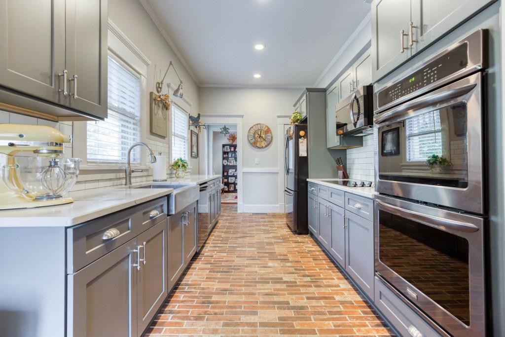 304 Edwards Street Monroe, GA 30655 - Photo 12 of 64 a large kitchen with stainless steel appliances kitchen island granite countertop a stove a sink and a refrigerator