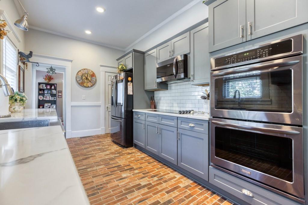 304 Edwards Street Monroe, GA 30655 - Photo 13 of 64 a kitchen with stainless steel appliances granite countertop a refrigerator stove and microwave