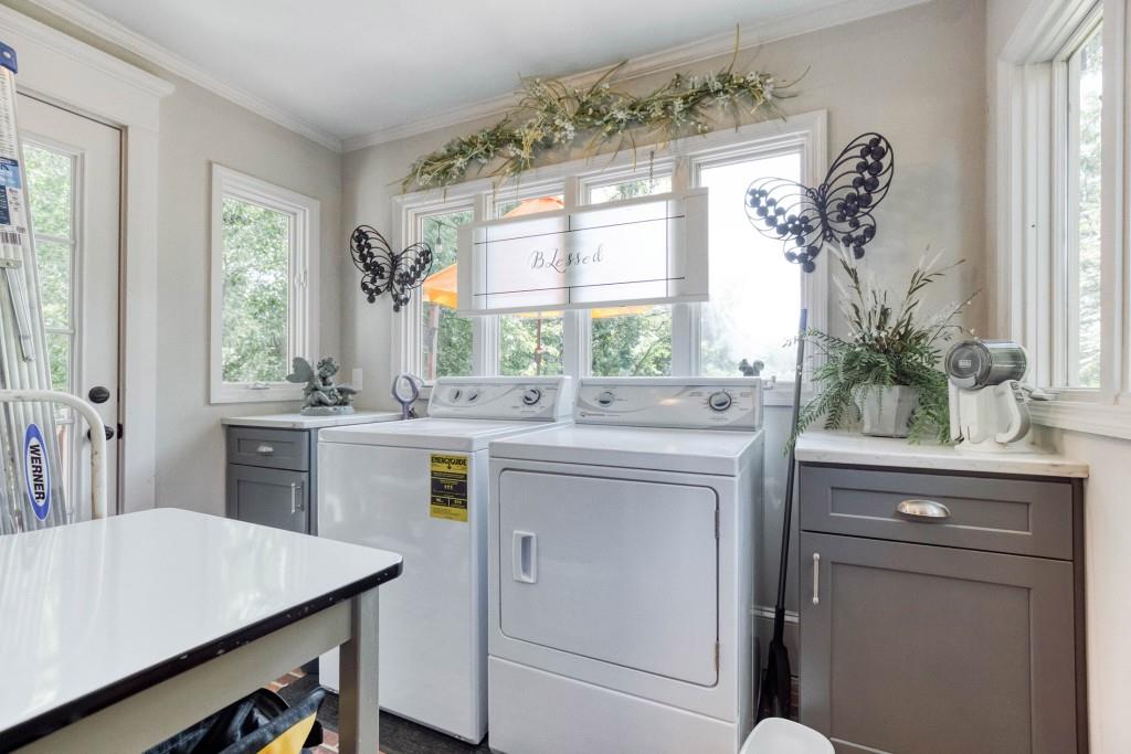 304 Edwards Street Monroe, GA 30655 - Photo 15 of 64 a kitchen with white cabinets and window