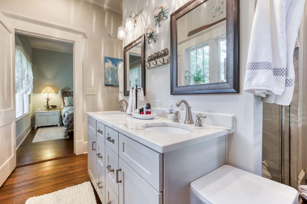 304 Edwards Street Monroe, GA 30655 - Photo 21 of 64 a spacious bathroom with a double vanity sink a mirror and a toilet