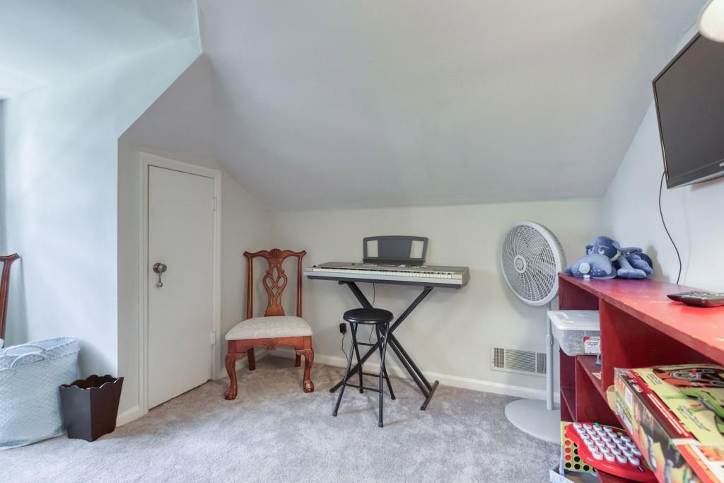 304 Edwards Street Monroe, GA 30655 - Photo 31 of 64 a view of a workspace with furniture and a window