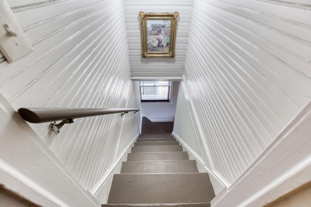 304 Edwards Street Monroe, GA 30655 - Photo 37 of 64 a view of a hallway with wooden floor and stairs