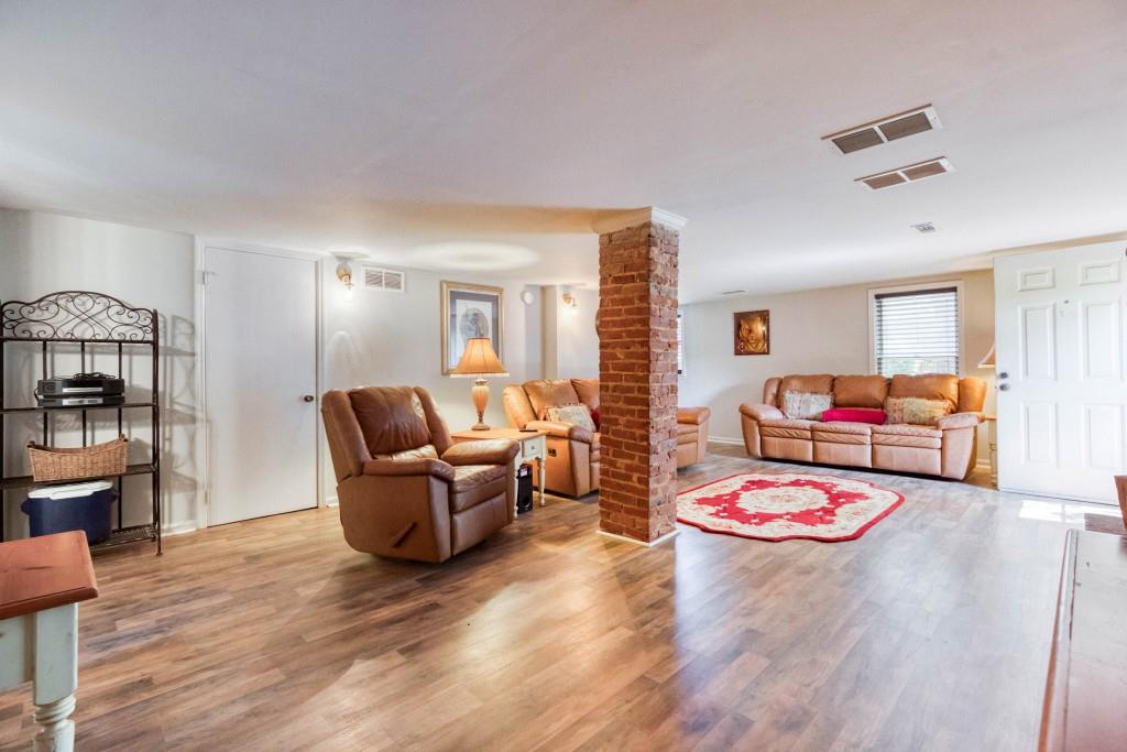 304 Edwards Street Monroe, GA 30655 - Photo 39 of 64 a living room with furniture and wooden floor