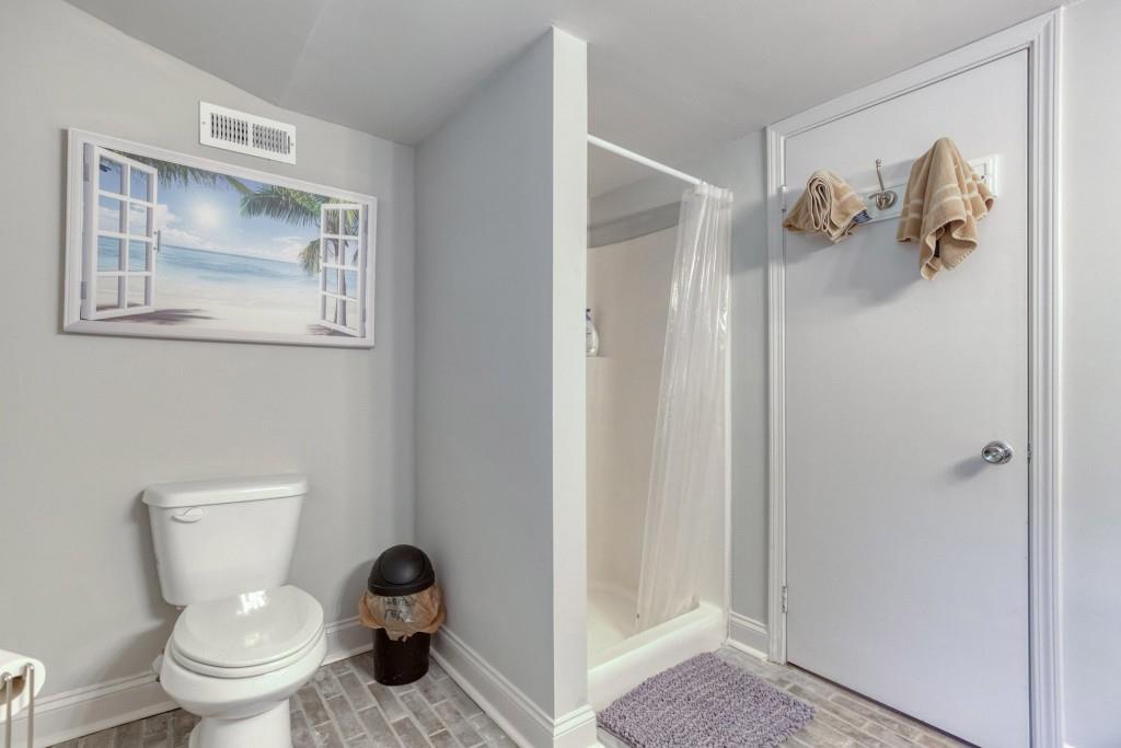 304 Edwards Street Monroe, GA 30655 - Photo 41 of 64 a bathroom with a toilet and a shower