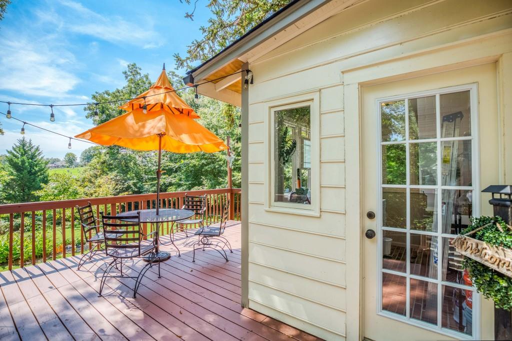 304 Edwards Street Monroe, GA 30655 - Photo 42 of 64 a view of balcony with wooden floor and seating space