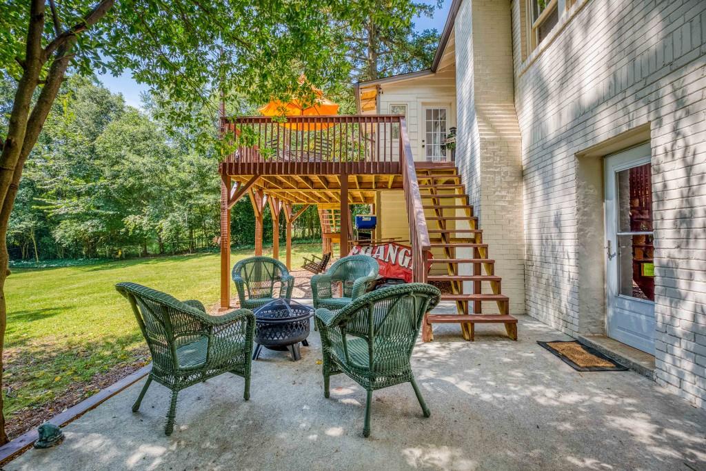 304 Edwards Street Monroe, GA 30655 - Photo 44 of 64 a view of a chairs and table in the patio next to a yard