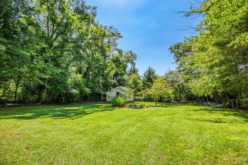 304 Edwards Street Monroe, GA 30655 - Photo 48 of 64 a view of a grassy field with trees in the background
