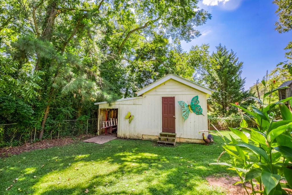 304 Edwards Street Monroe, GA 30655 - Photo 50 of 64 a view of a backyard with a garden