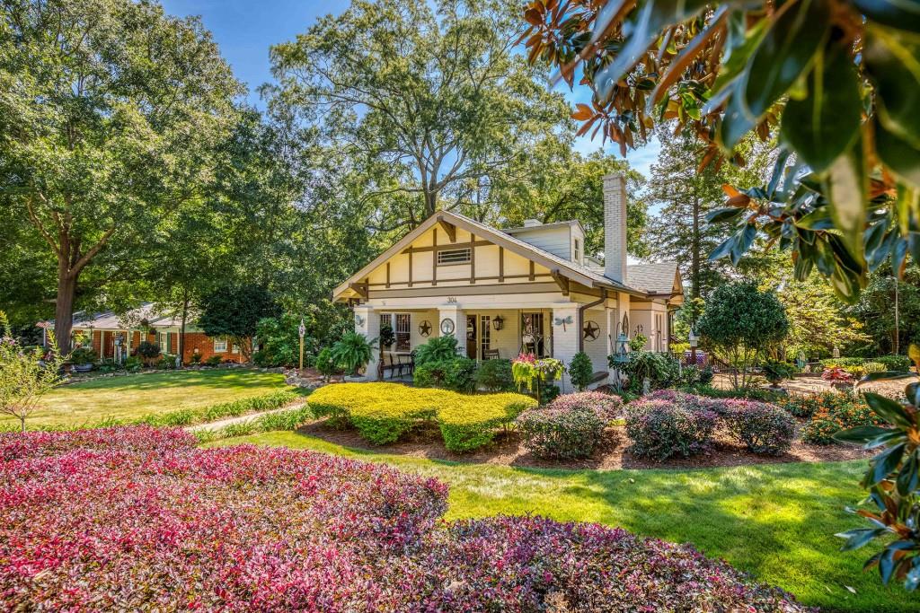 304 Edwards Street Monroe, GA 30655 - Photo 64 of 64 a front view of a house with a garden and trees