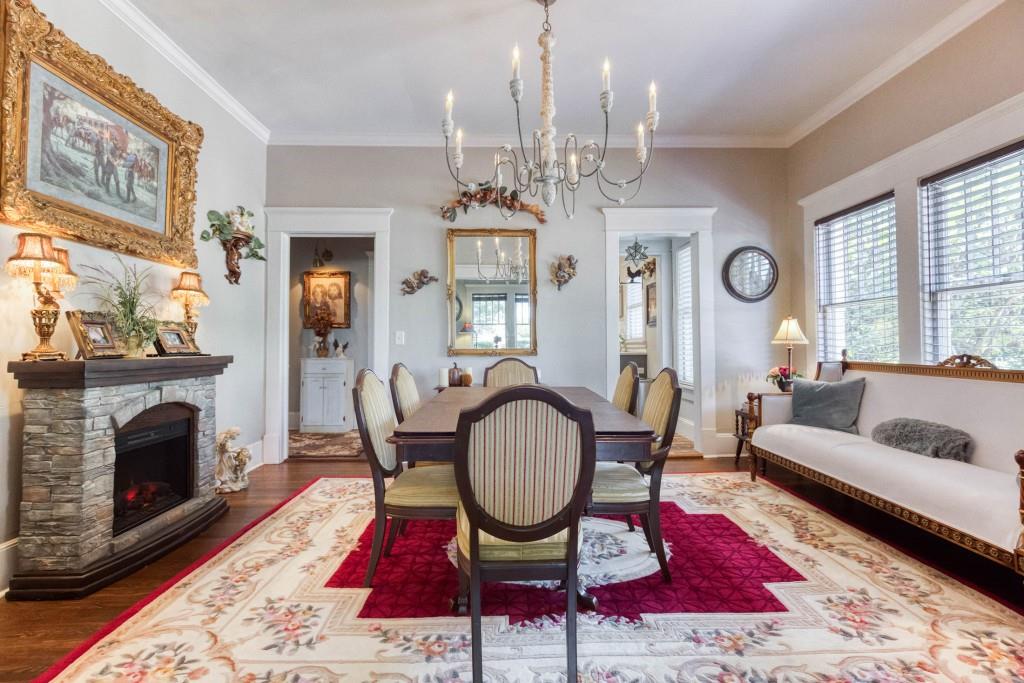 304 Edwards Street Monroe, GA 30655 - Photo 7 of 64 a living room with furniture a fireplace a chandelier and a window