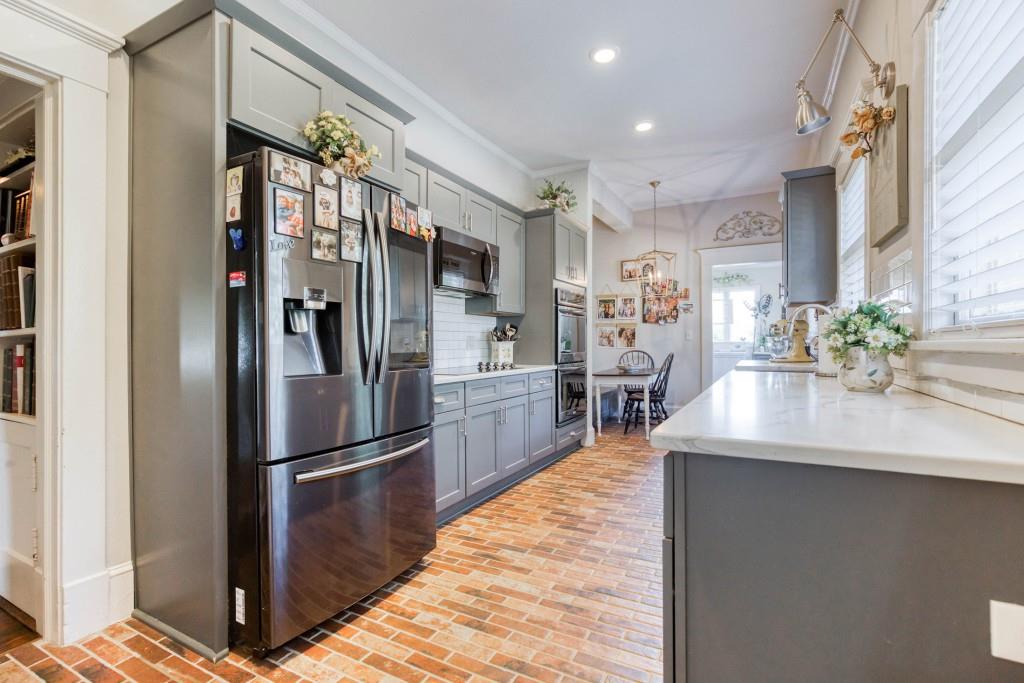 304 Edwards Street Monroe, GA 30655 - Photo 10 of 64 a kitchen with stainless steel appliances granite countertop a refrigerator and a sink