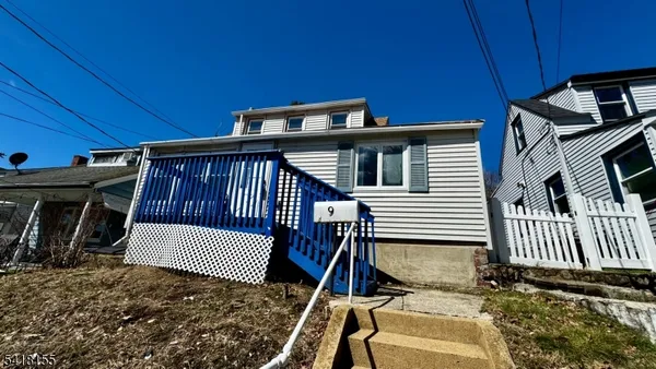 a view of a house with wooden deck
