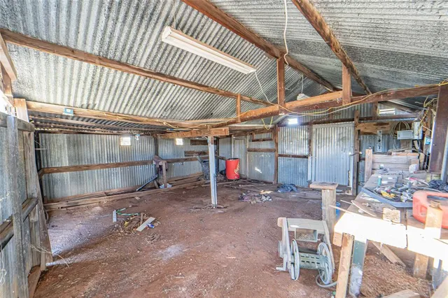 a view of a room with wooden shelves