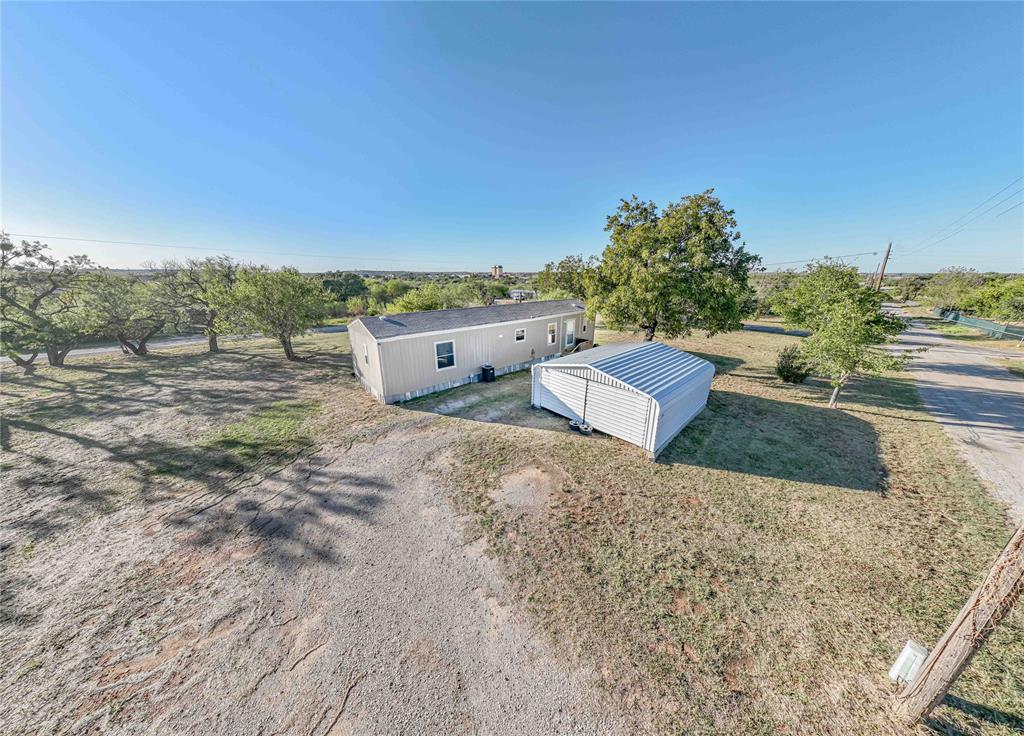 605 South Butte Street Breckenridge, TX 76424 - Photo 3 of 26 a view of a dry yard with wooden fence