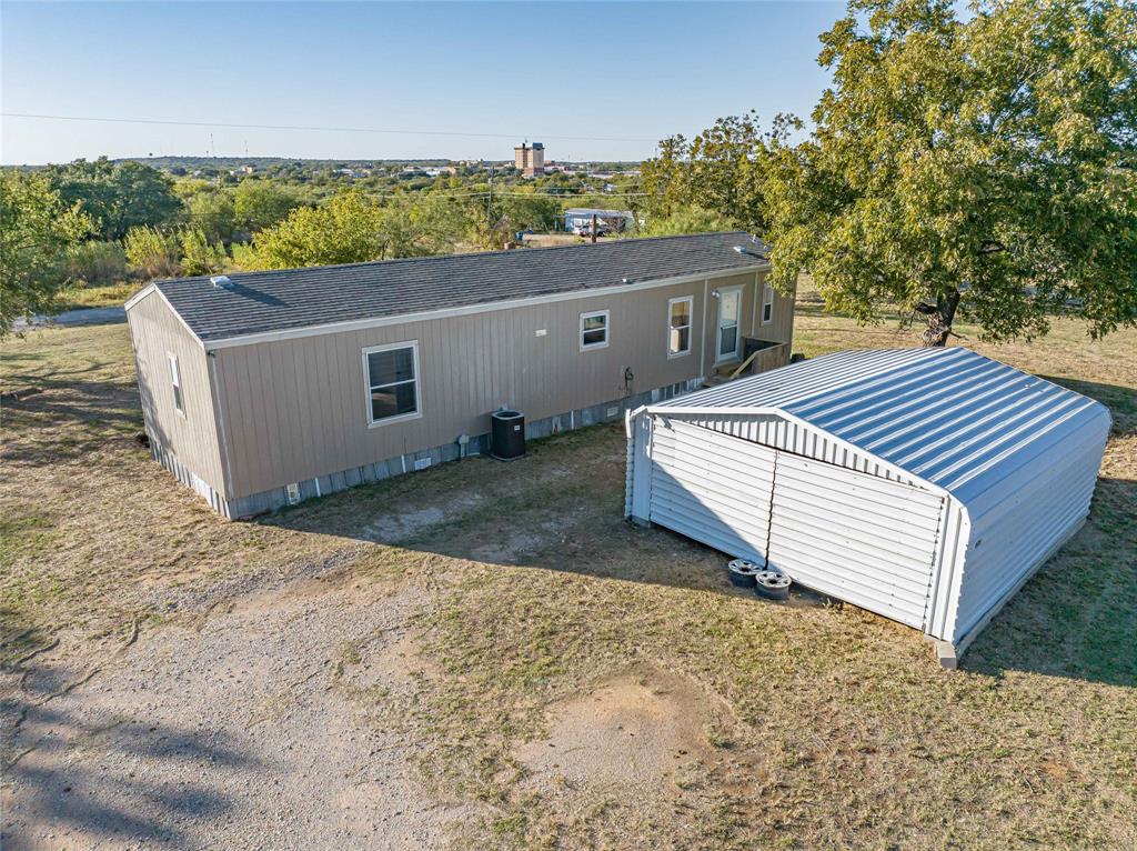 605 South Butte Street Breckenridge, TX 76424 - Photo 4 of 26 a view of a roof deck with wooden floor and fence