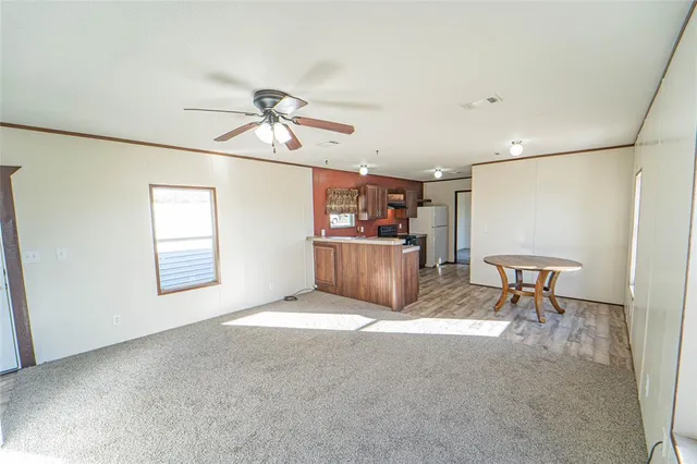 a view of a livingroom with furniture and a ceiling fan