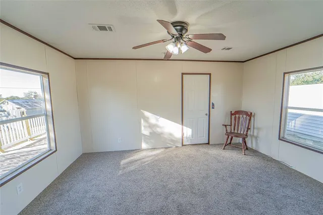 a view of an empty room with windows
