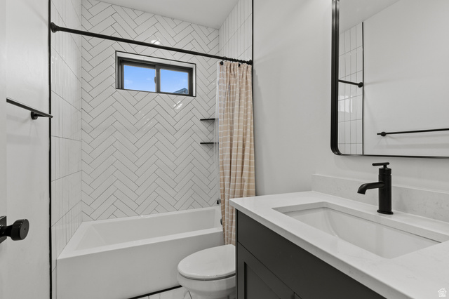 3111 South 1250 West Logan, UT 84321 - Photo 22 of 51 Bathroom featuring a white subway tile shower surround in a herringbone pattern with built-in shelving, a single vanity with a white countertop and integrated sink, a rectangular mirror with a black frame, and matte black fixtures throughout