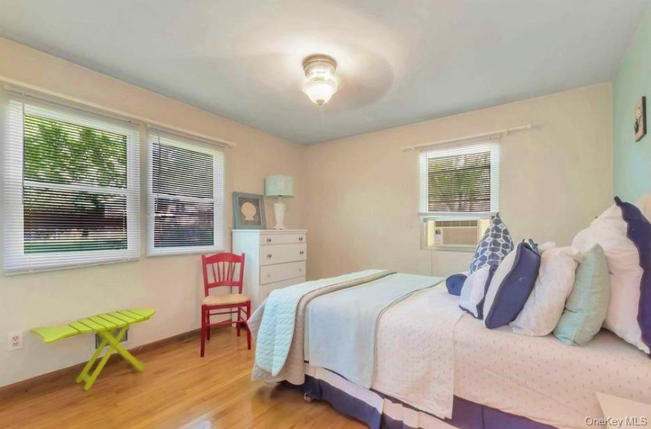 430 Grove Road Southold, NY 11971 - Photo 11 of 15 a bedroom with a bed and a window