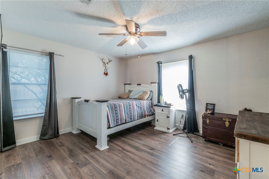508 Straws Mill Road Gatesville, TX 76528 - Photo 12 of 26 Bedroom with ceiling fan and wood flooring