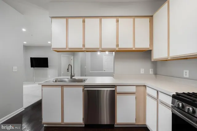 a kitchen with stainless steel appliances granite countertop a sink and a stove