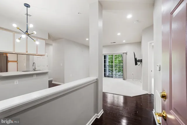 a view of a kitchen with wooden floor and a window