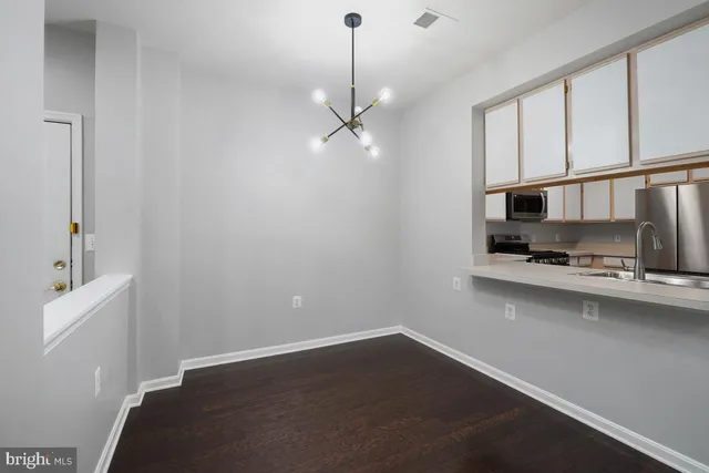 a hallway with a sink and chandelier