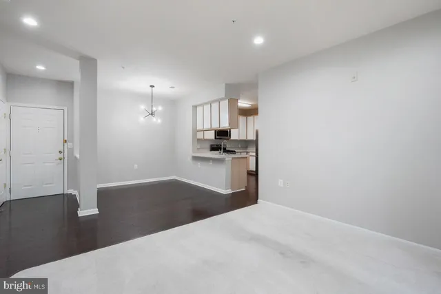 a kitchen with granite countertop white cabinets and stainless steel appliances