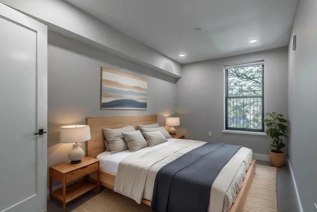 a bedroom with a bed and a window