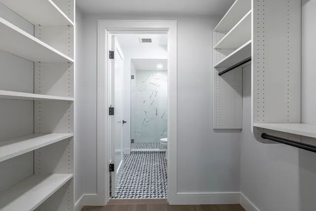 a bathroom with a sink toilet double vanity and shower