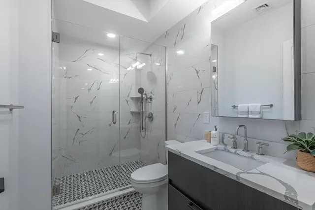 a bedroom with a bed and a painting on the wall