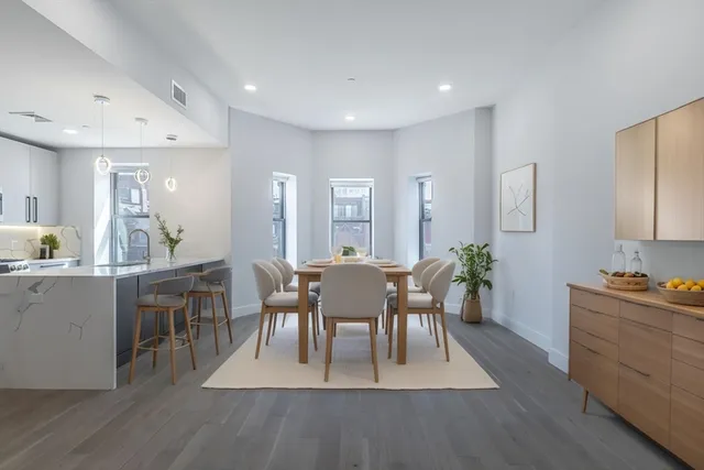 a view of a dining room with furniture and wooden floor