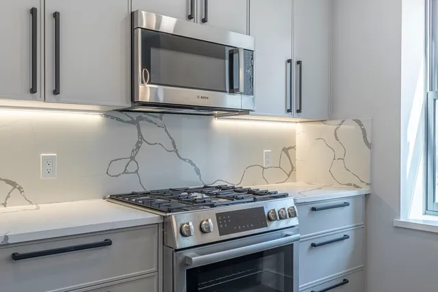 a kitchen with a stove and a microwave