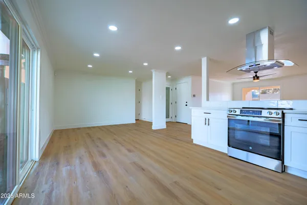 a view of kitchen with sink and wooden floor