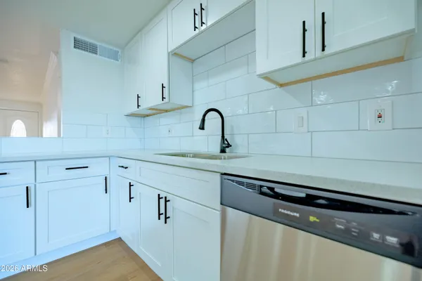 a kitchen with a sink cabinets and appliances