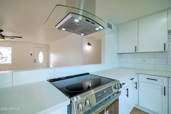 a kitchen with a cabinets and white appliances