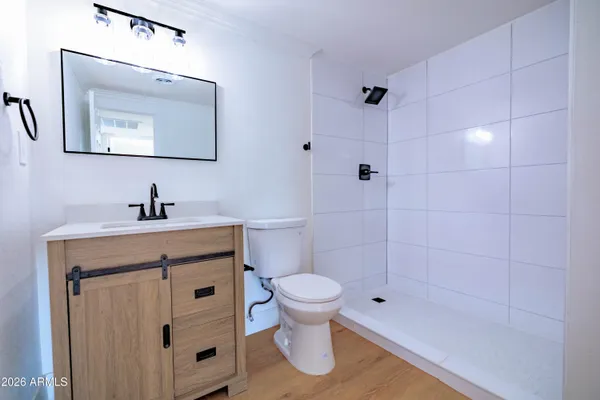 a bathroom with a toilet sink and shower