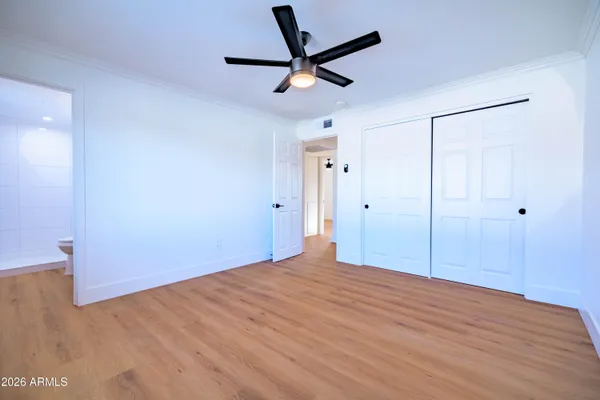 a view of empty room with wooden floor