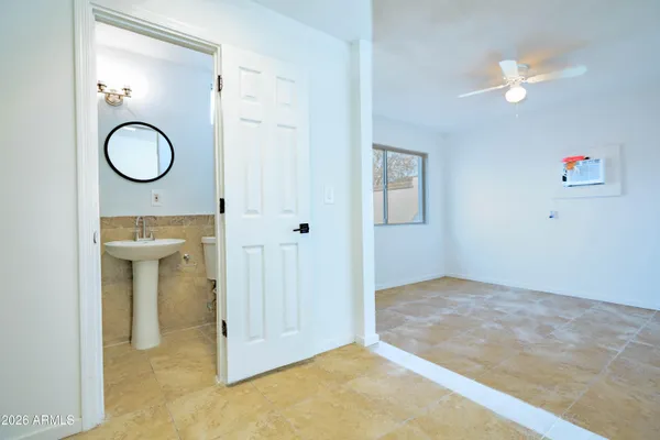a view of a room with wooden floor and mirror