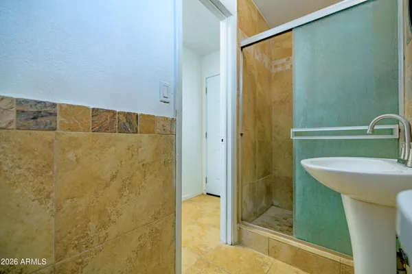 a bathroom with a shower and a sink
